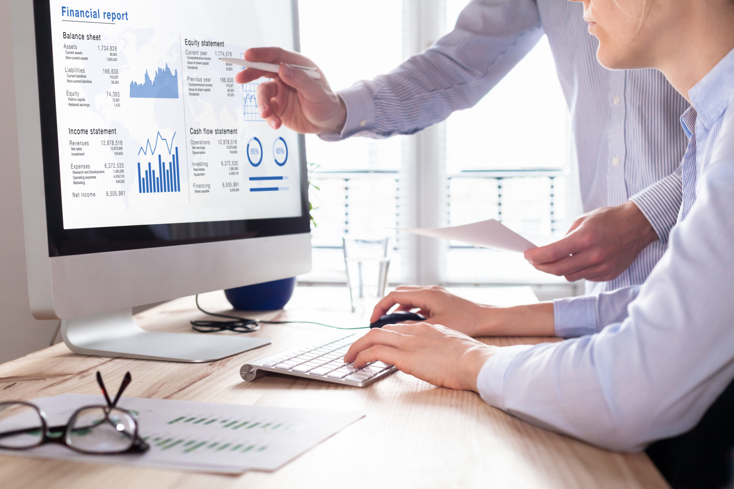 Consulting auditors auditing financial report on computer screen, business charts Modern Solutions