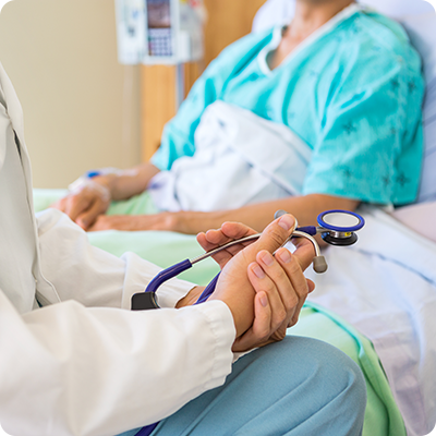 Doctor talking to patient in bed