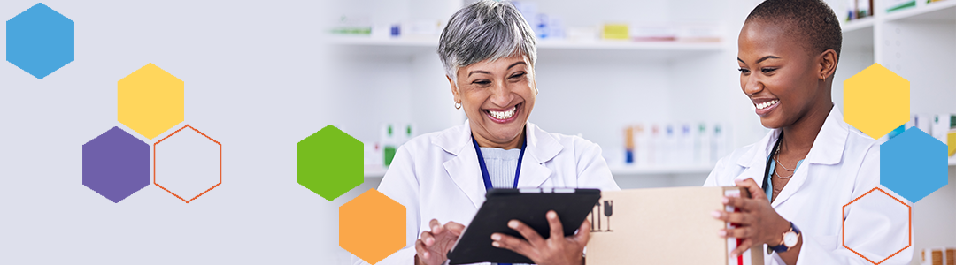 Female doctor and nurse smiling looking at iPad